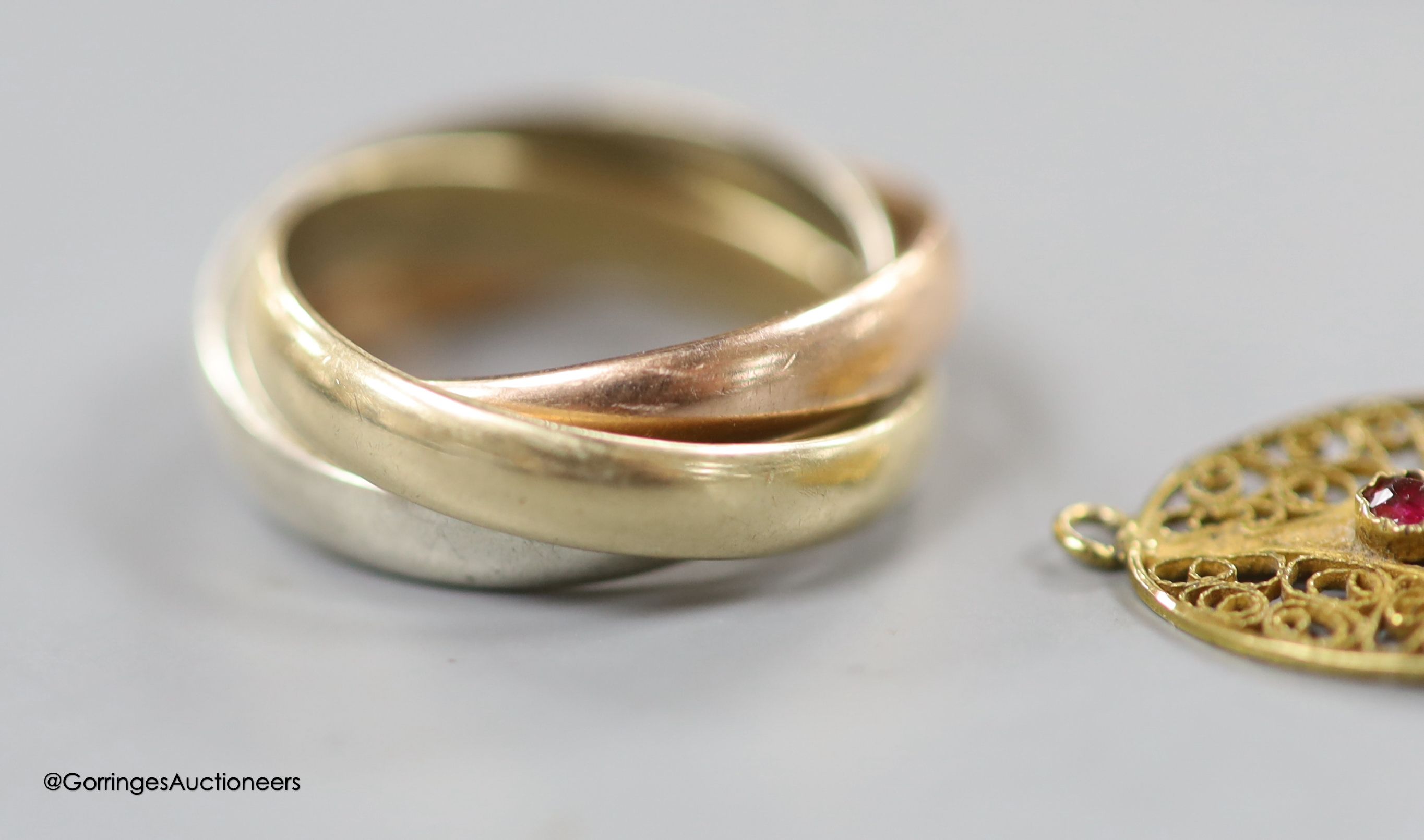 A 9ct three-colour gold puzzle ring, a Victorian yellow metal, 4.8 grams, rose diamond and onyx mourning brooch and four other items